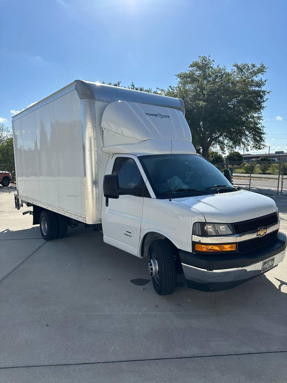Aerodynamic spoiler installed on a white box truck